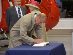 The Duke of Edinburgh signs the Visitors Book